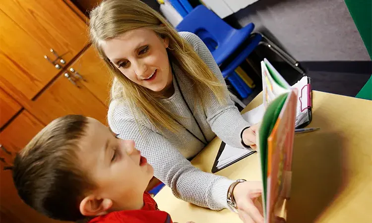 teacher helps a student